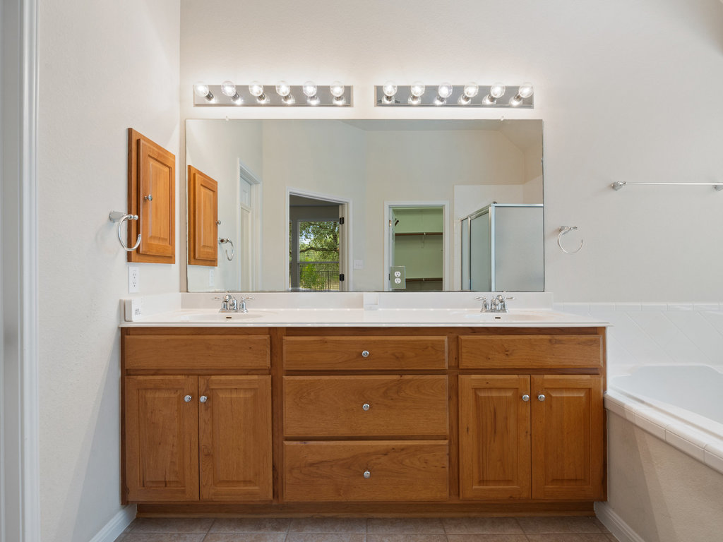 1858 Nelson Ranch Loop Cedar Park, TX 78613 - Photo 26 of 32 Full bathroom with double vanity, a bath, a stall shower, and light tile patterned flooring