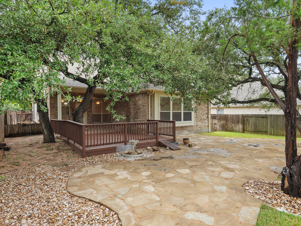 1858 Nelson Ranch Loop Cedar Park, TX 78613 - Photo 30 of 32 Back of house with a fenced backyard, a wooden deck, and brick siding