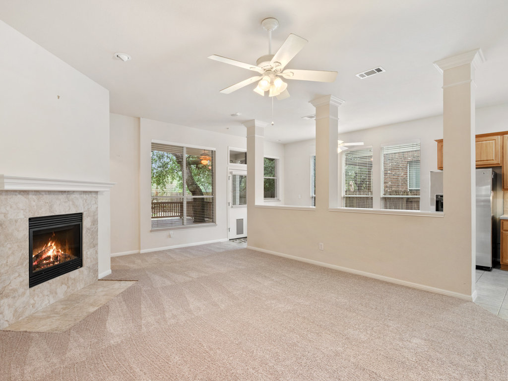 1858 Nelson Ranch Loop Cedar Park, TX 78613 - Photo 5 of 32 Unfurnished living room with a ceiling fan, plenty of natural light, and a tile fireplace