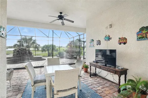 a living room with patio furniture and a flat screen tv