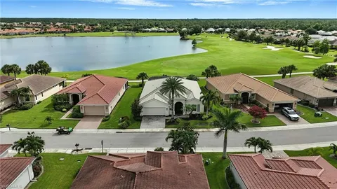 an aerial view of a house with yard lake view and boat