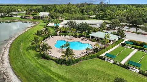 an aerial view of residential house with outdoor space and trees all around