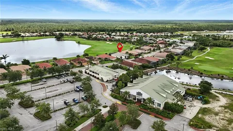 an aerial view of a city with lots of residential buildings ocean and mountain view in back