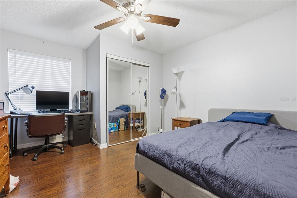 3705 Southwest 27th Street, Unit 717 Gainesville, FL 32608 - Photo 11 of 24 a bedroom with a bed and a flat screen tv