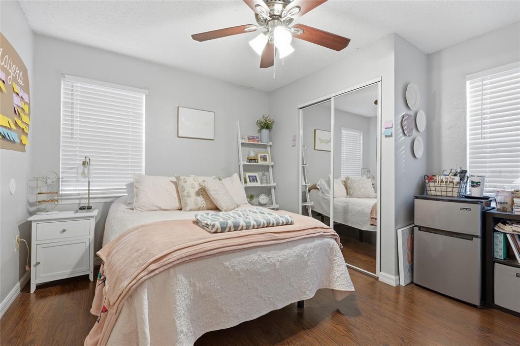 3705 Southwest 27th Street, Unit 717 Gainesville, FL 32608 - Photo 15 of 24 a bedroom with a bed and a chandelier