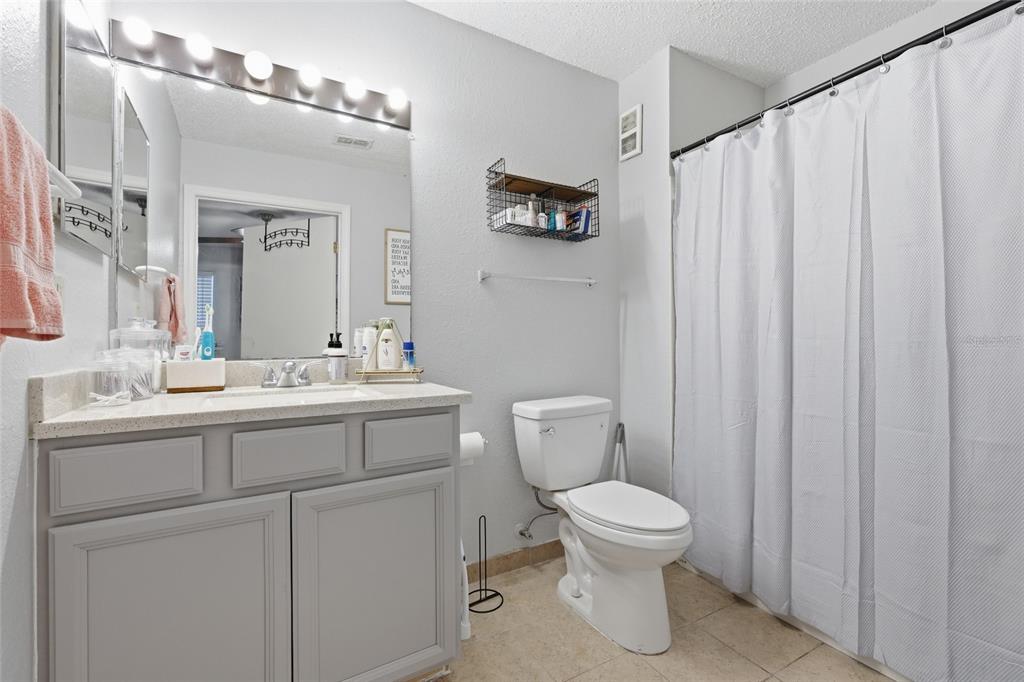 3705 Southwest 27th Street, Unit 717 Gainesville, FL 32608 - Photo 16 of 24 a bathroom with a toilet sink and mirror