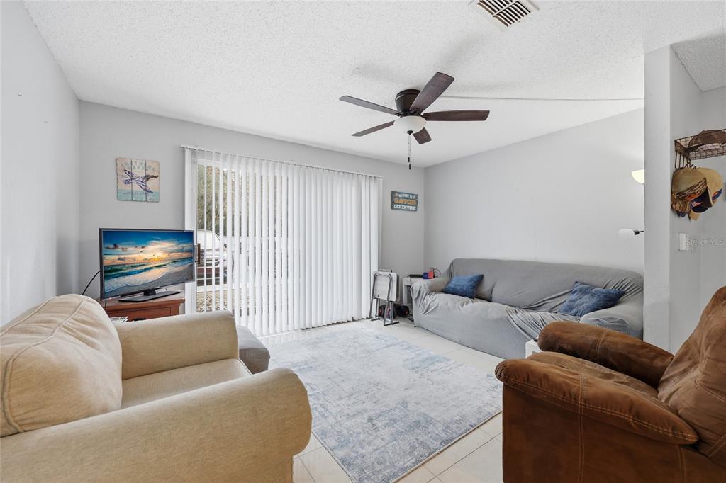 3705 Southwest 27th Street, Unit 717 Gainesville, FL 32608 - Photo 5 of 24 a living room with furniture and a flat screen tv