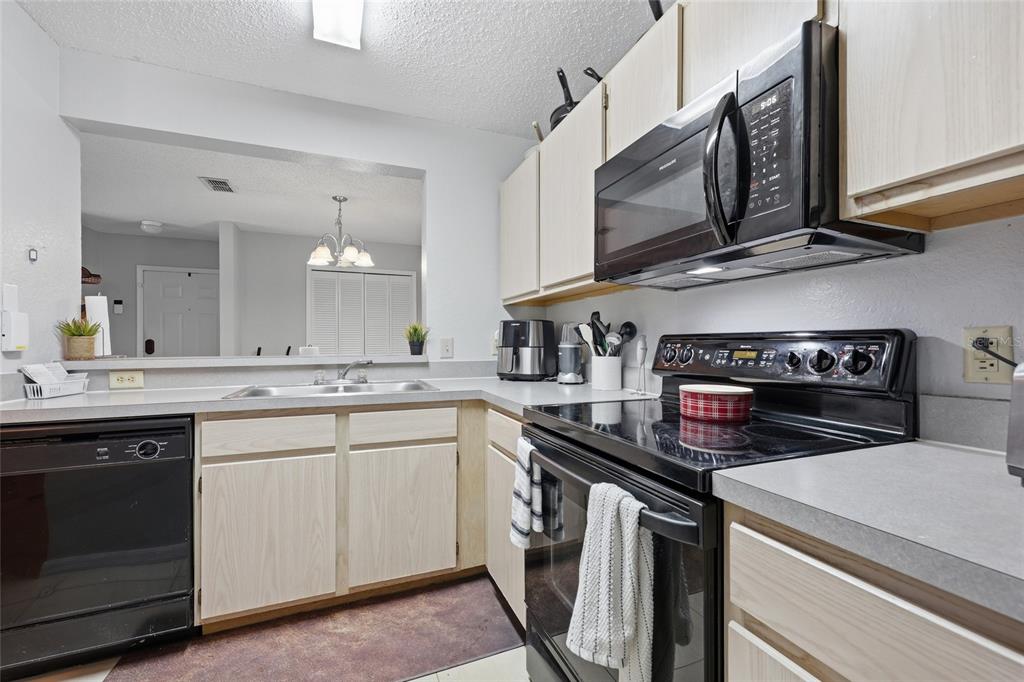 3705 Southwest 27th Street, Unit 717 Gainesville, FL 32608 - Photo 8 of 24 a kitchen with stainless steel appliances granite countertop a stove and a sink