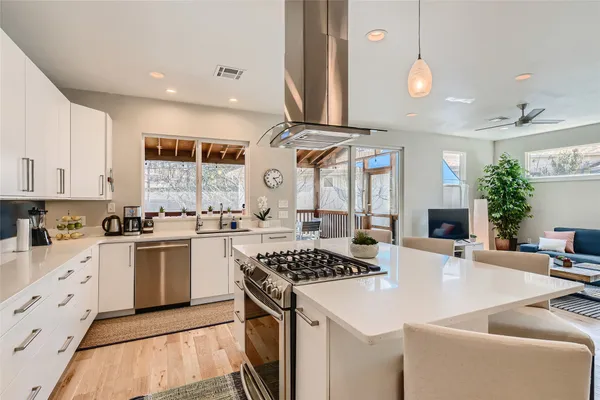 a kitchen with stainless steel appliances kitchen island granite countertop a sink and cabinets