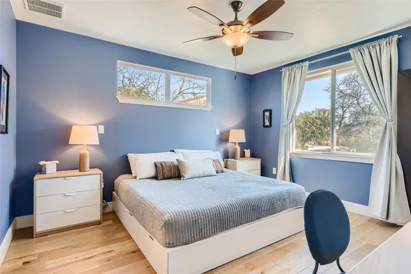 a bedroom with a large bed and a window