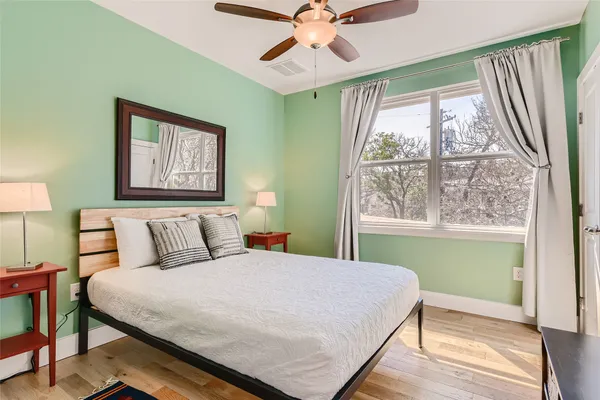 a bedroom with a large bed and a window