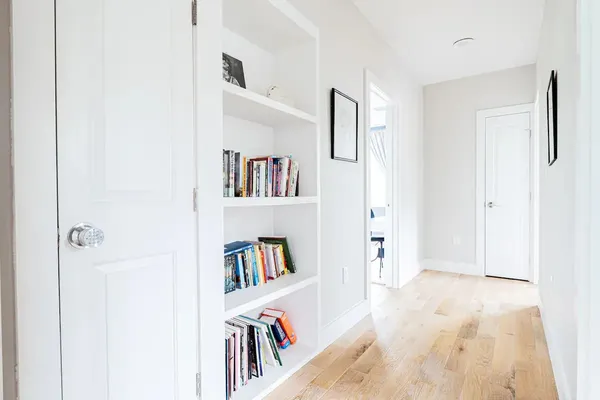 a view of a livingroom with a book shelf