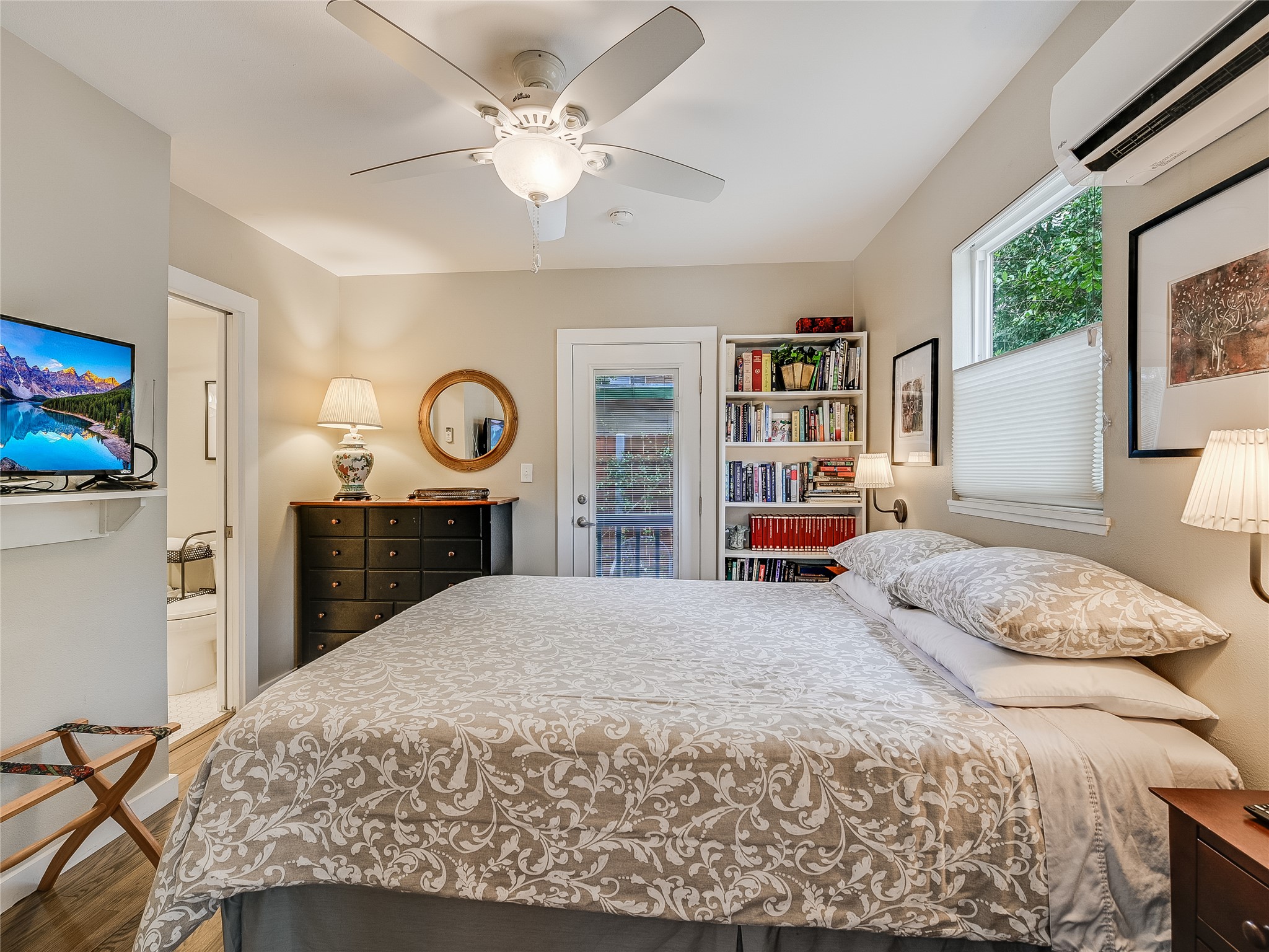 1205 Enfield Road Austin, TX 78703 - Photo 24 of 34 a bedroom with a large bed and a chandelier