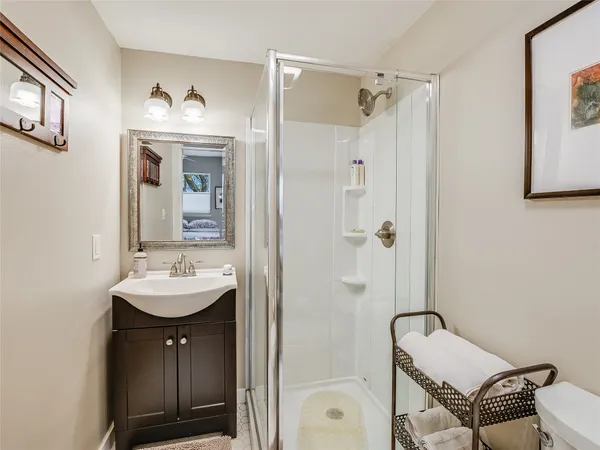 a bathroom with a sink a mirror a bathtub and shower