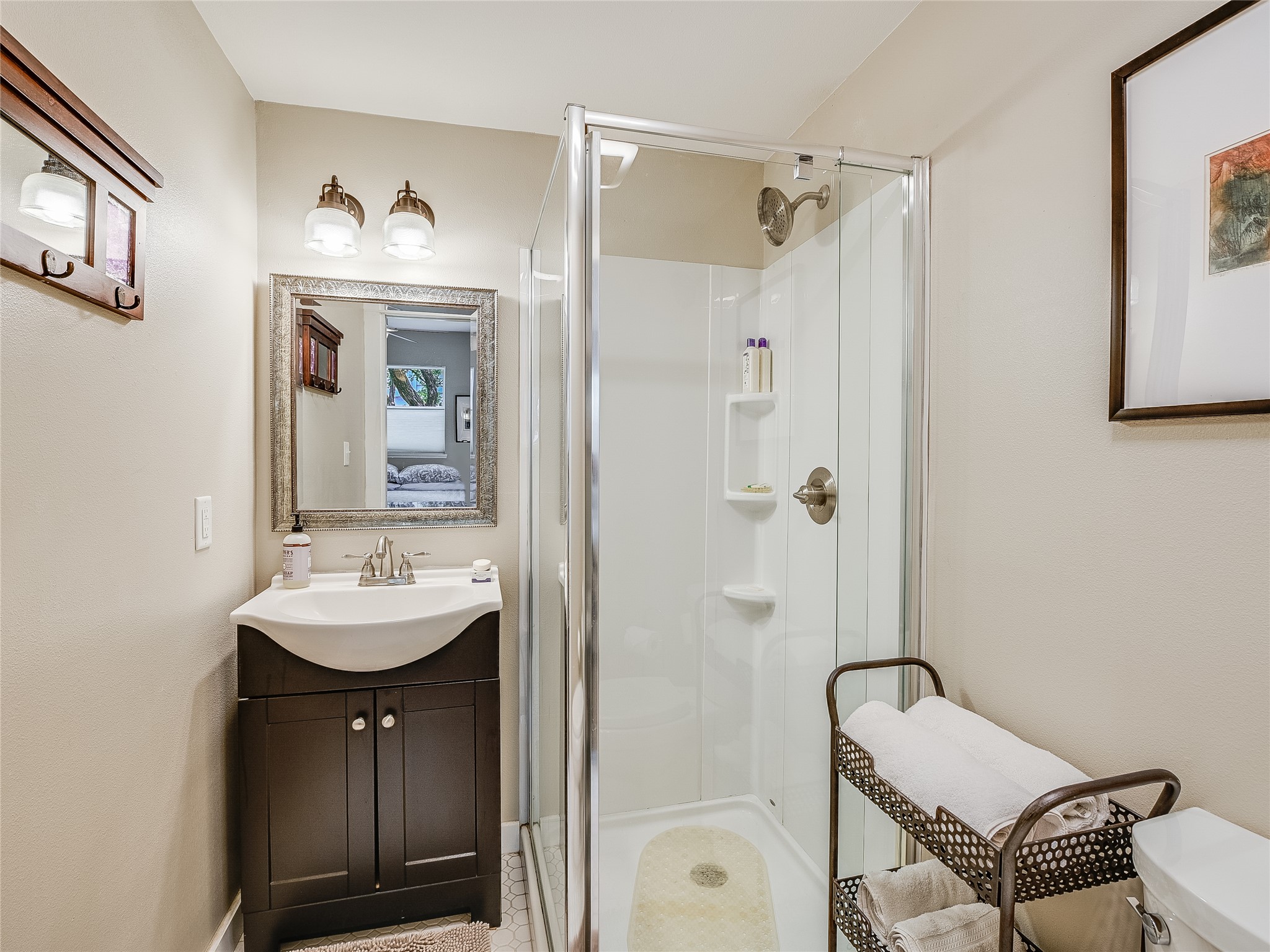 1205 Enfield Road Austin, TX 78703 - Photo 25 of 34 a bathroom with a sink a mirror a bathtub and shower