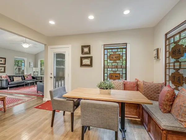 a dining room with furniture and wooden floor