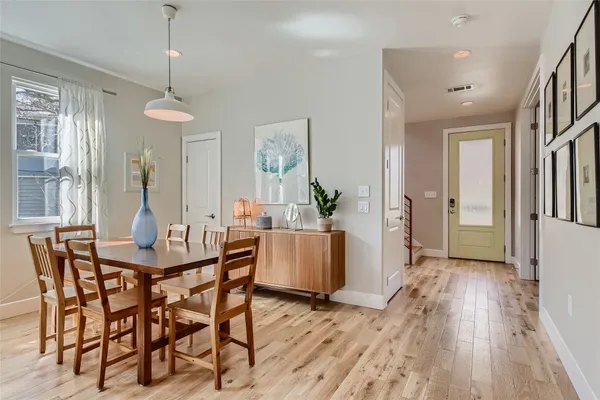 a view of a dining room with furniture window and wooden floor