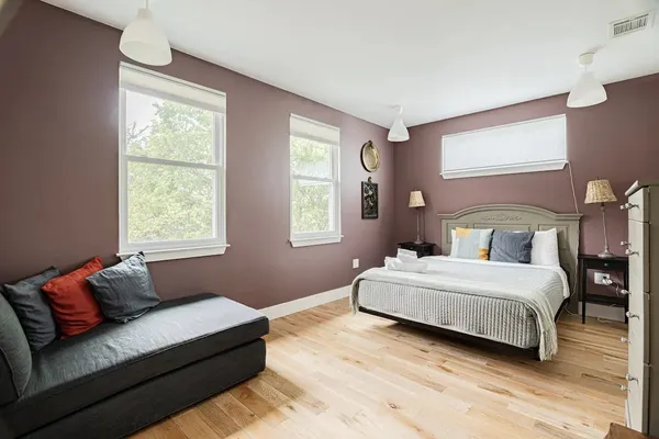 a bedroom with a bed window and couch