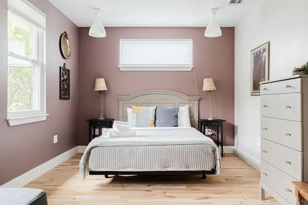 a bedroom with a bed and a window