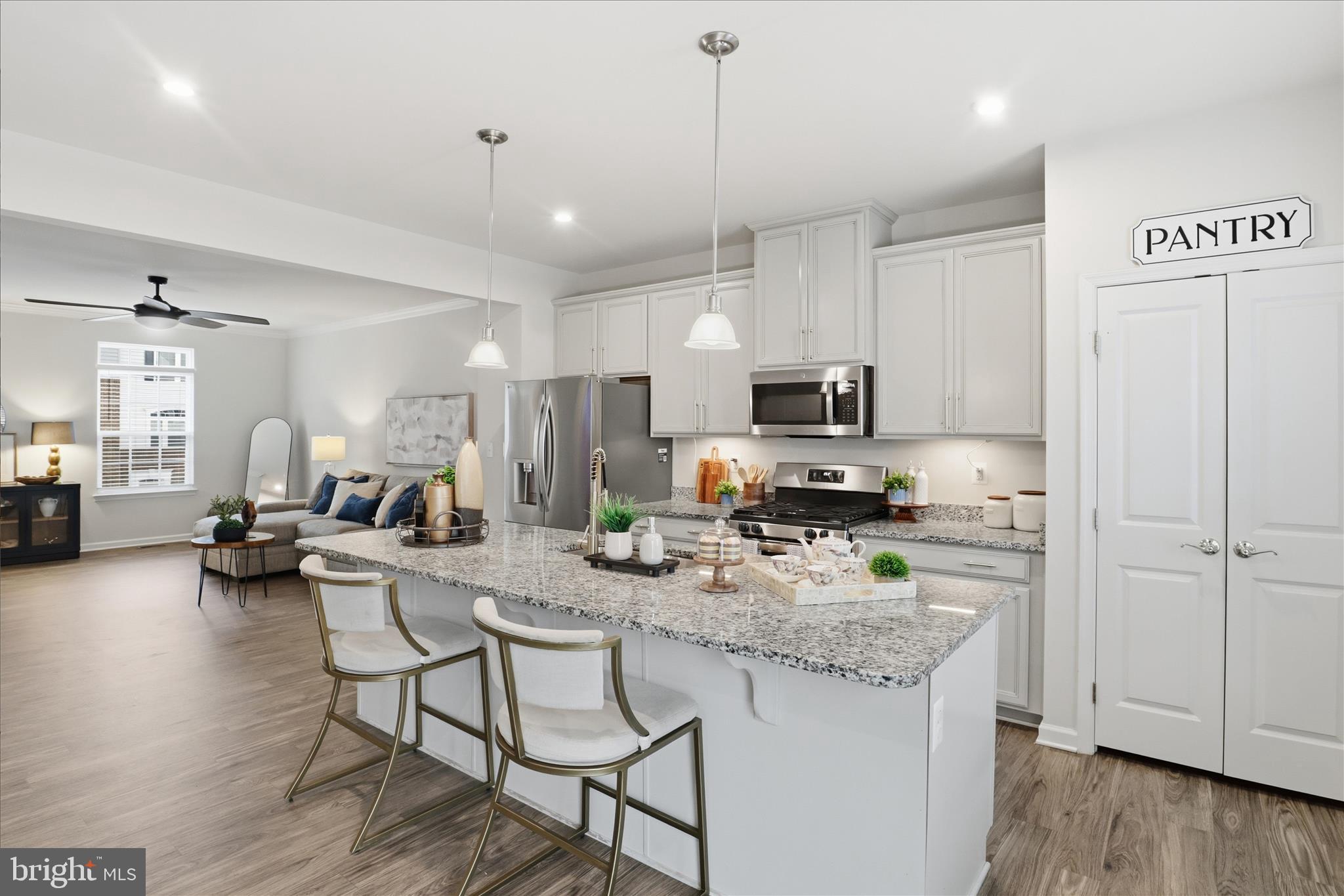 506 View Point Way Fredericksburg, VA 22405 - Photo 11 of 39 a kitchen with sink a stove and chairs with wooden floor