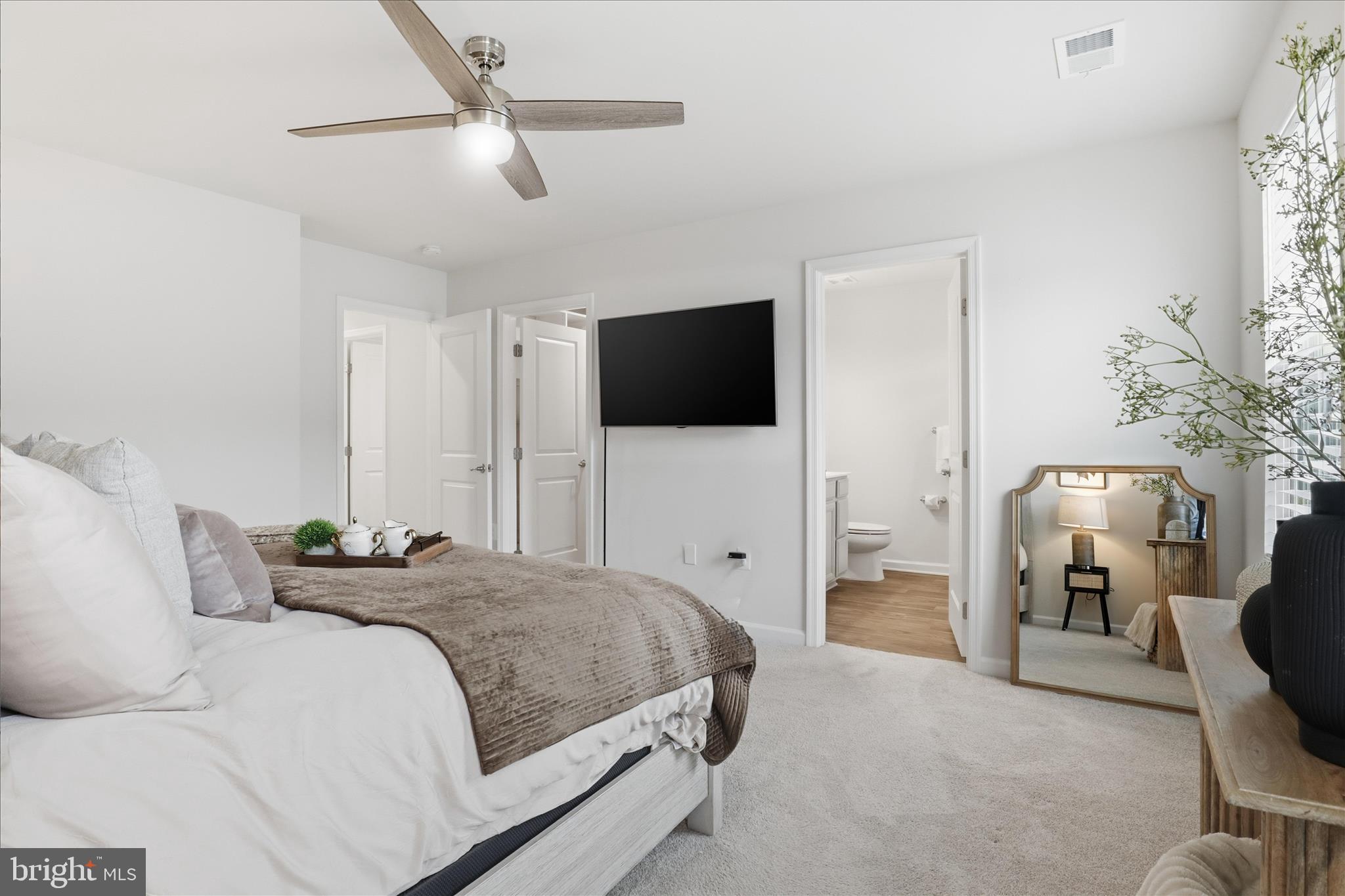506 View Point Way Fredericksburg, VA 22405 - Photo 19 of 39 a bedroom with a bed a couch and a flat screen tv