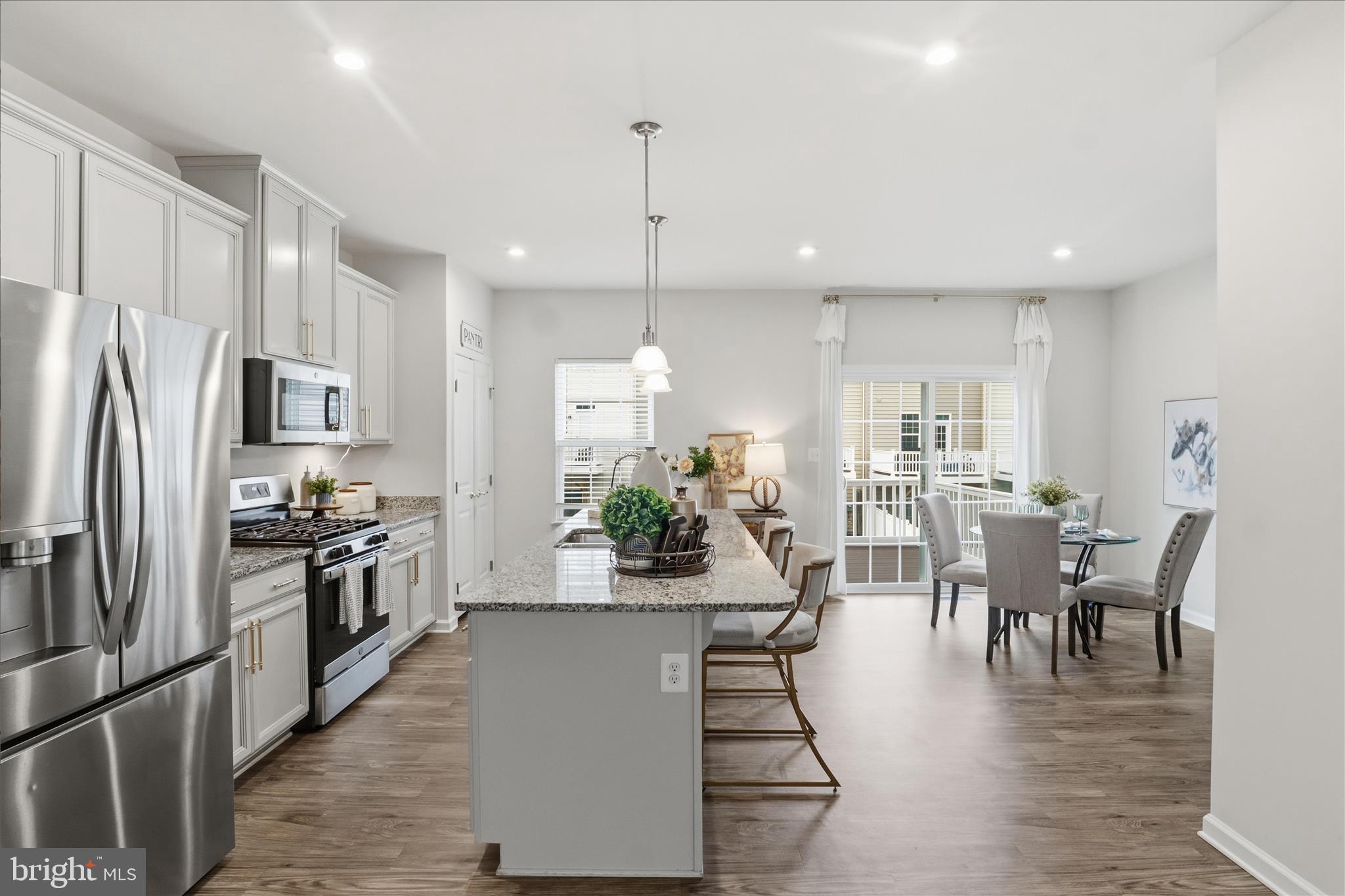 506 View Point Way Fredericksburg, VA 22405 - Photo 8 of 39 a kitchen with stainless steel appliances granite countertop a refrigerator a stove top oven a dining table and chairs