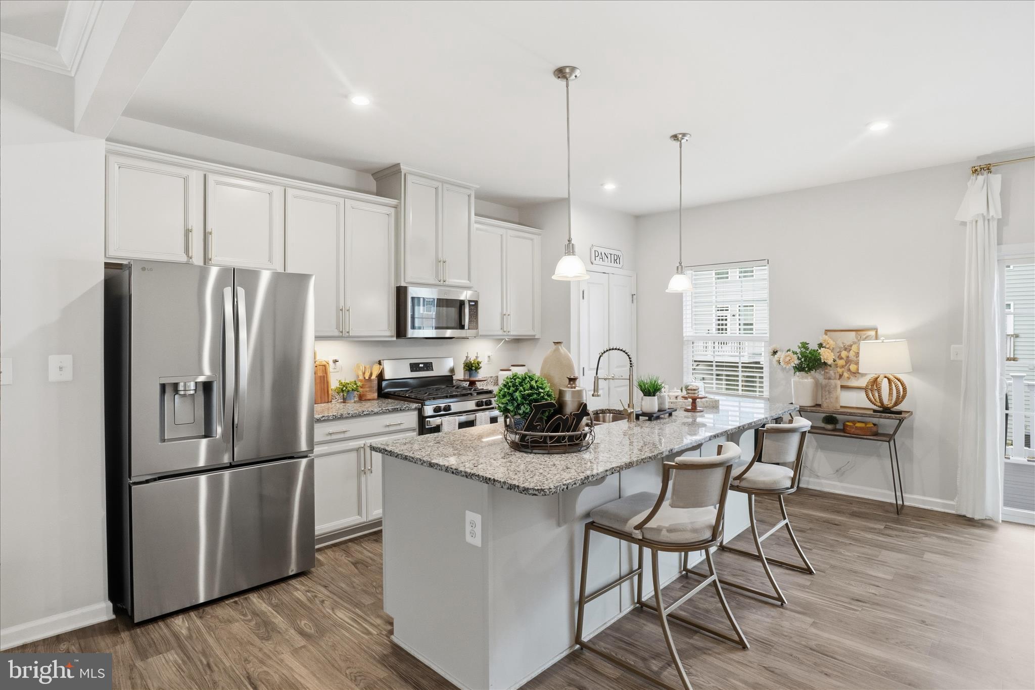 506 View Point Way Fredericksburg, VA 22405 - Photo 9 of 39 a kitchen with stainless steel appliances a refrigerator a stove a sink and chairs