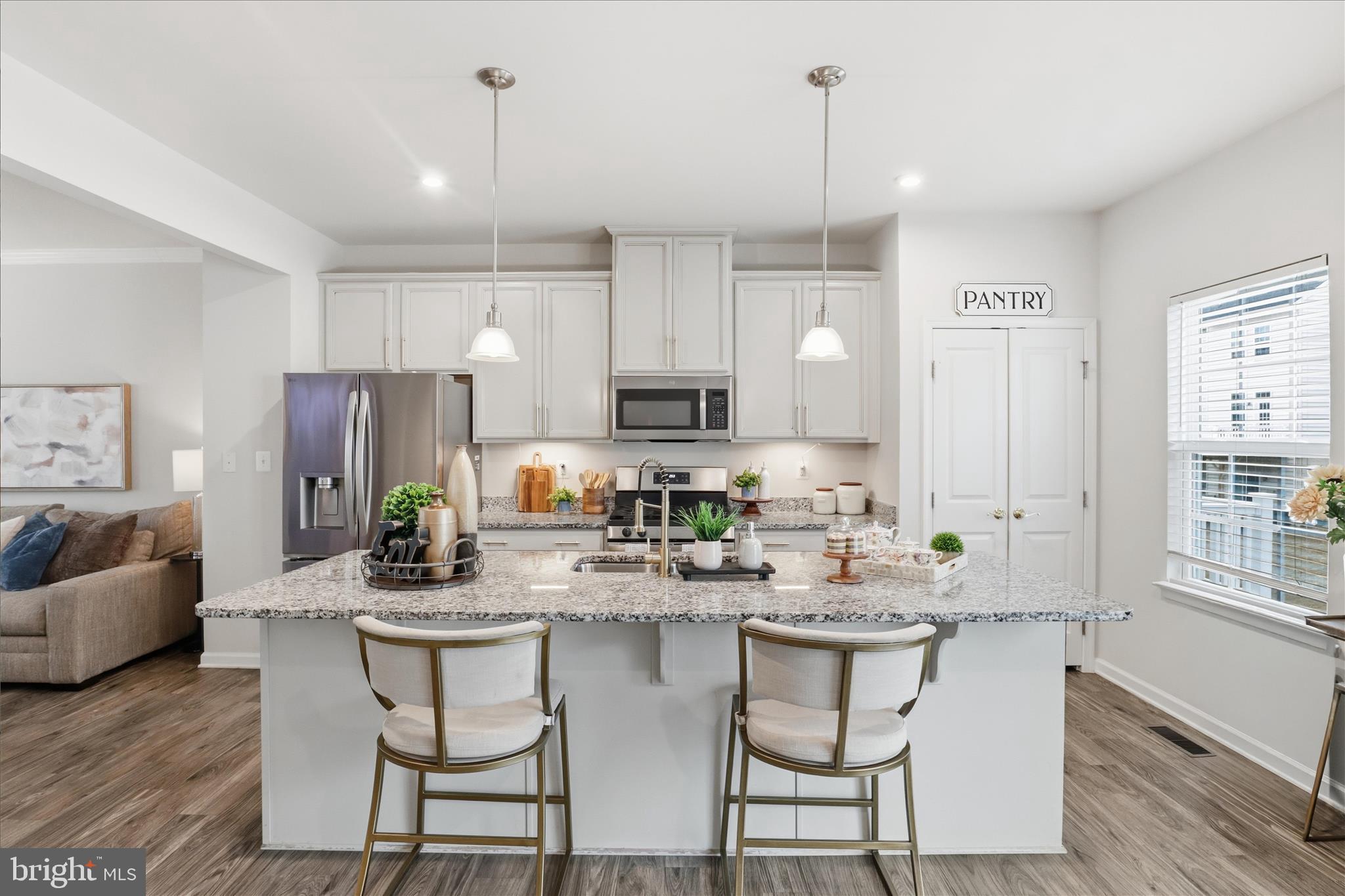 506 View Point Way Fredericksburg, VA 22405 - Photo 10 of 39 a kitchen with stainless steel appliances kitchen island granite countertop a refrigerator a stove a sink and white cabinets with wooden floor