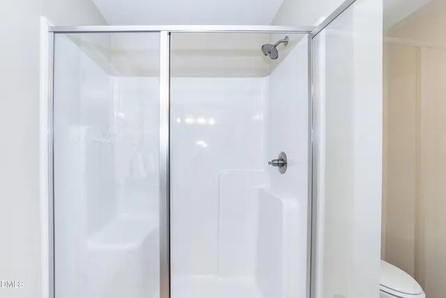 a bathroom with a glass shower door