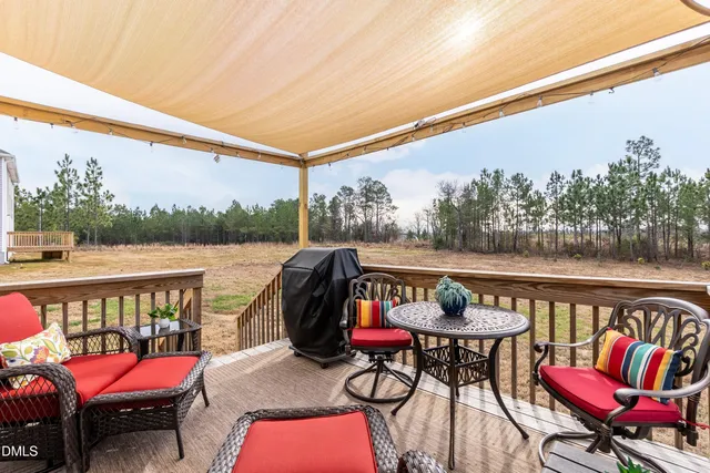 a patio with hardwood table and chairs