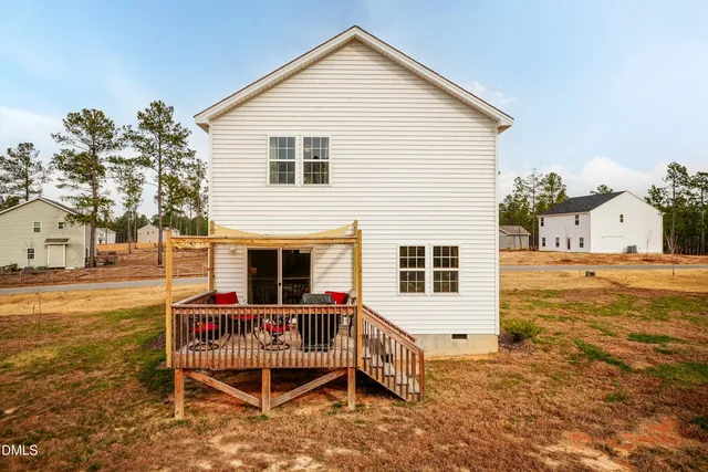 a view of a house with a yard and sitting area
