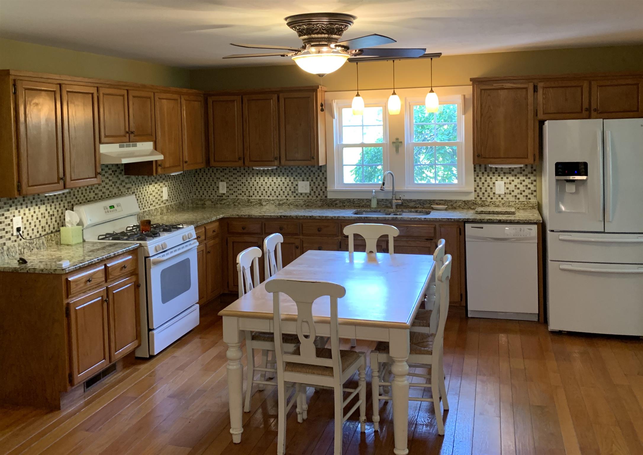 The kitchen has beautiful granite countertops and a custom tile backsplash.  