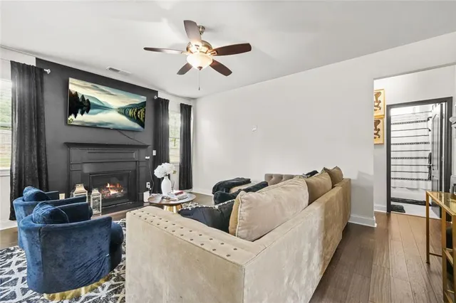 a living room with furniture kitchen view and a chandelier