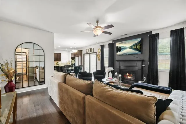 a living room with furniture and wooden floor