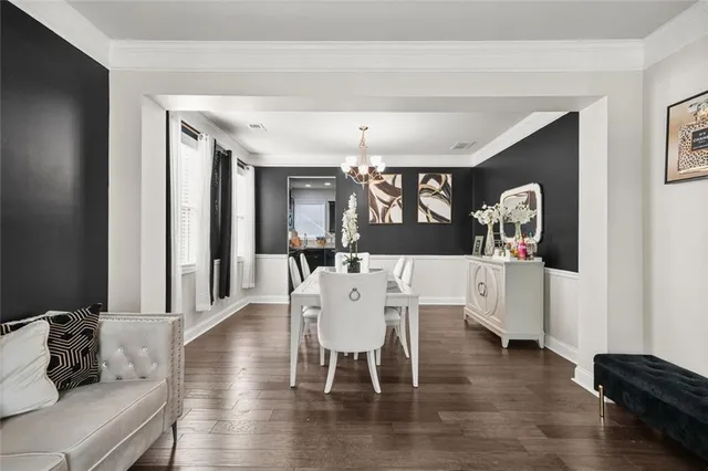 a view of a dining room with furniture wooden floor and chandelier
