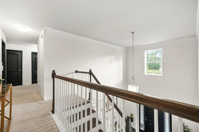 a spacious bedroom with a bed and a chandelier
