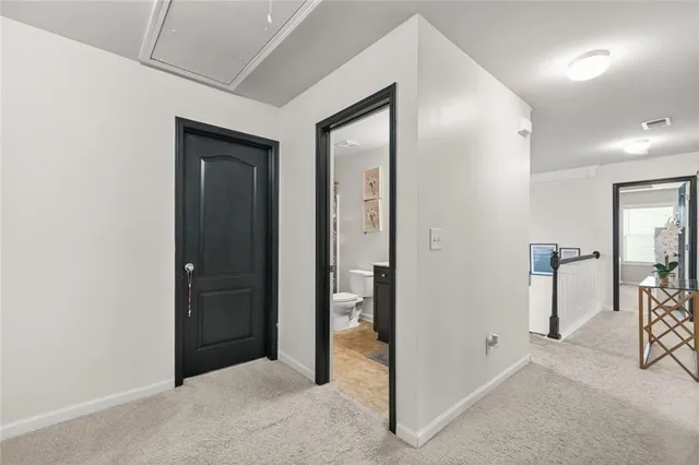 a spacious bedroom with a bed and a chandelier