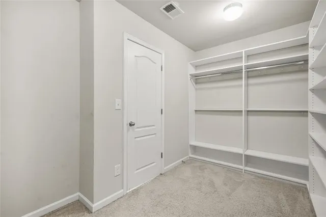 a bedroom with a bed and a dresser in it