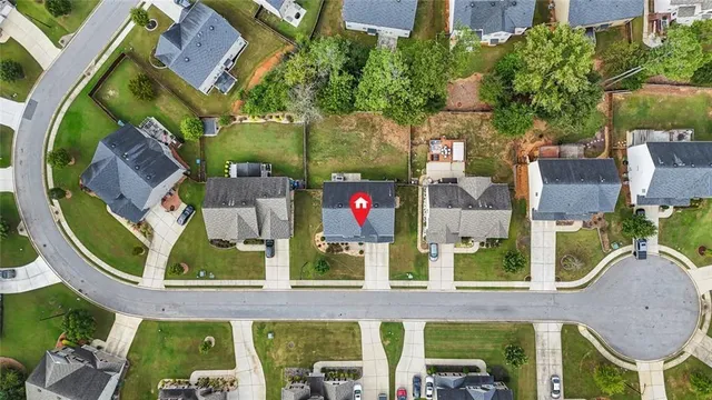an aerial view of a house with a yard
