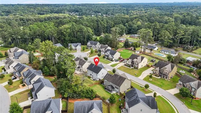 an aerial view of residential houses with outdoor space and parking
