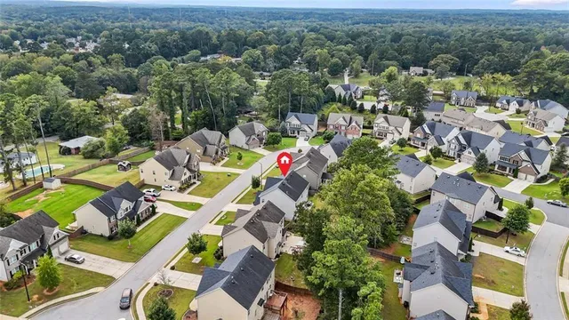 a backyard of a house with table and chairs