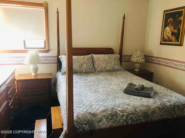 a bed sitting in a bedroom next to a window