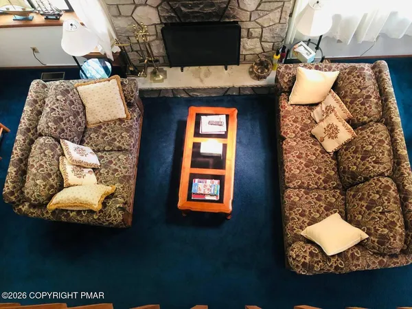 a kitchen with stainless steel appliances a dining table chairs and a refrigerator