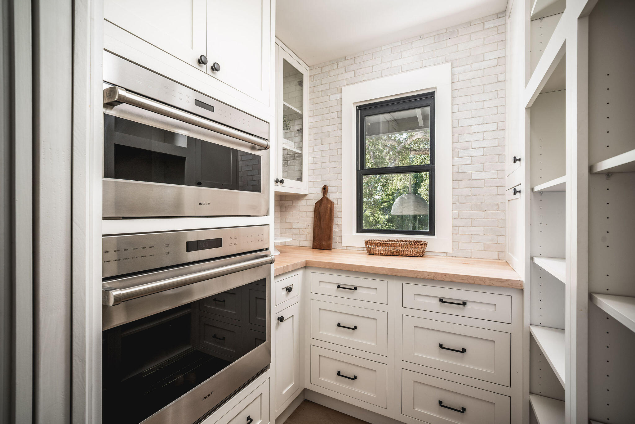 1383 School House Road Santa Barbara, CA 93108 - Photo 4 of 10 a kitchen with white cabinets and appliances
