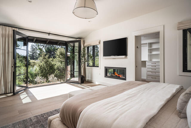 1383 School House Road Santa Barbara, CA 93108 - Photo 6 of 10 a spacious bedroom with a large bed and a flat screen tv