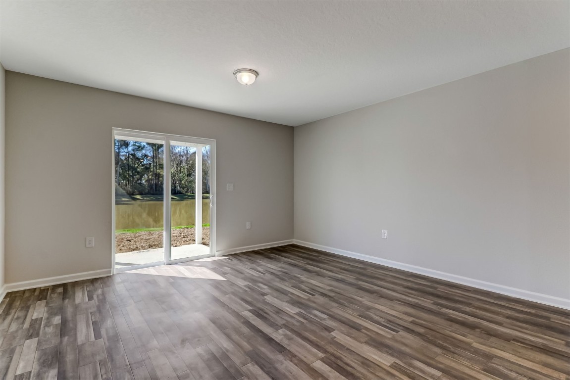 45177 Red Brick Drive Callahan, FL 32011 - Photo 5 of 13 wooden floor in an empty room with a window