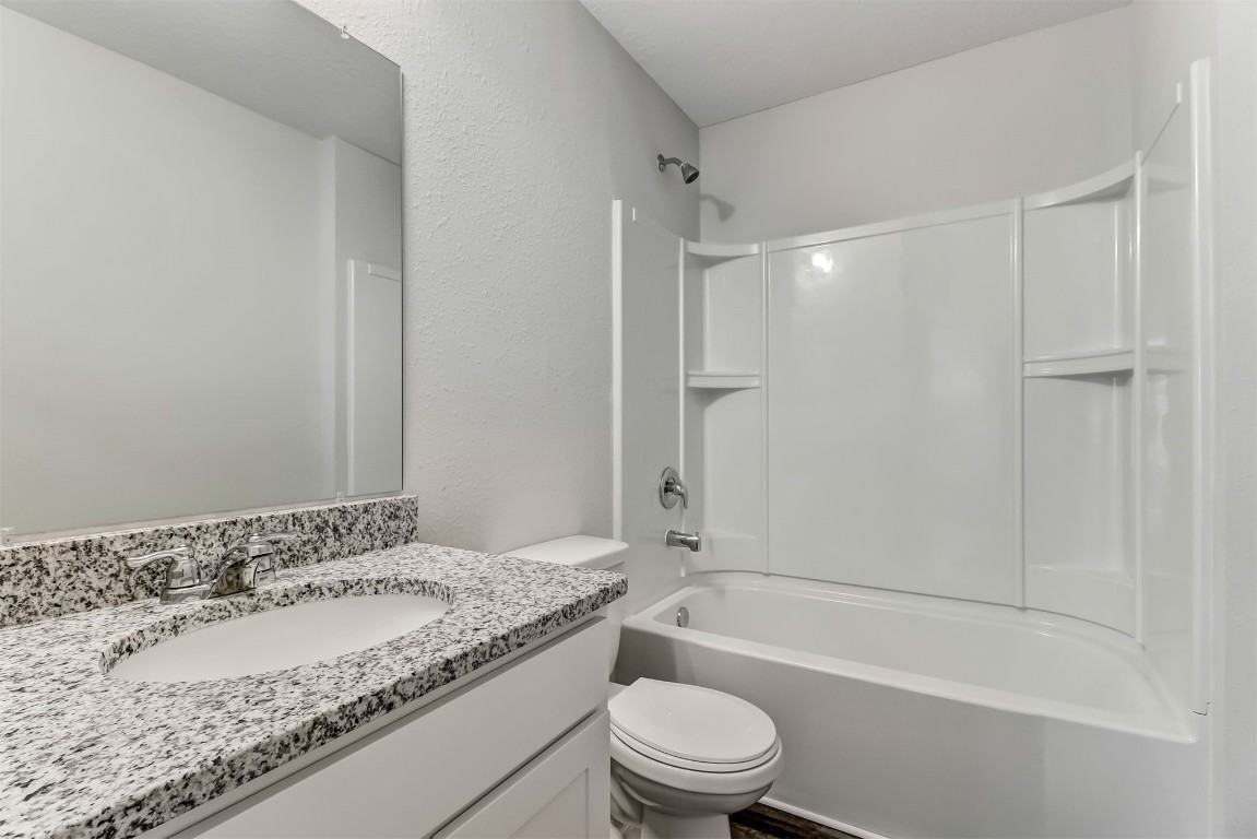 45177 Red Brick Drive Callahan, FL 32011 - Photo 6 of 13 a bathroom with a granite countertop sink a toilet and shower