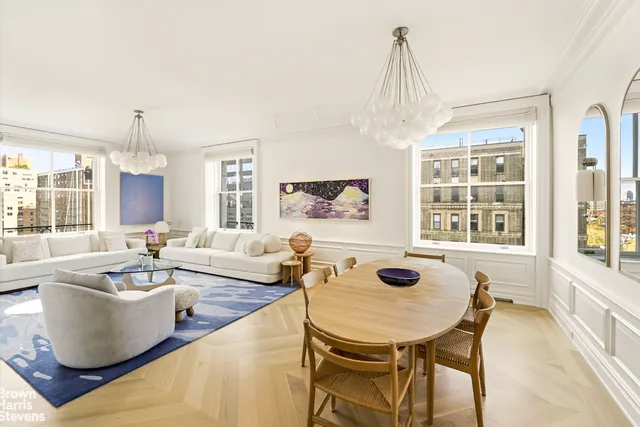 a living room with fireplace furniture and a chandelier