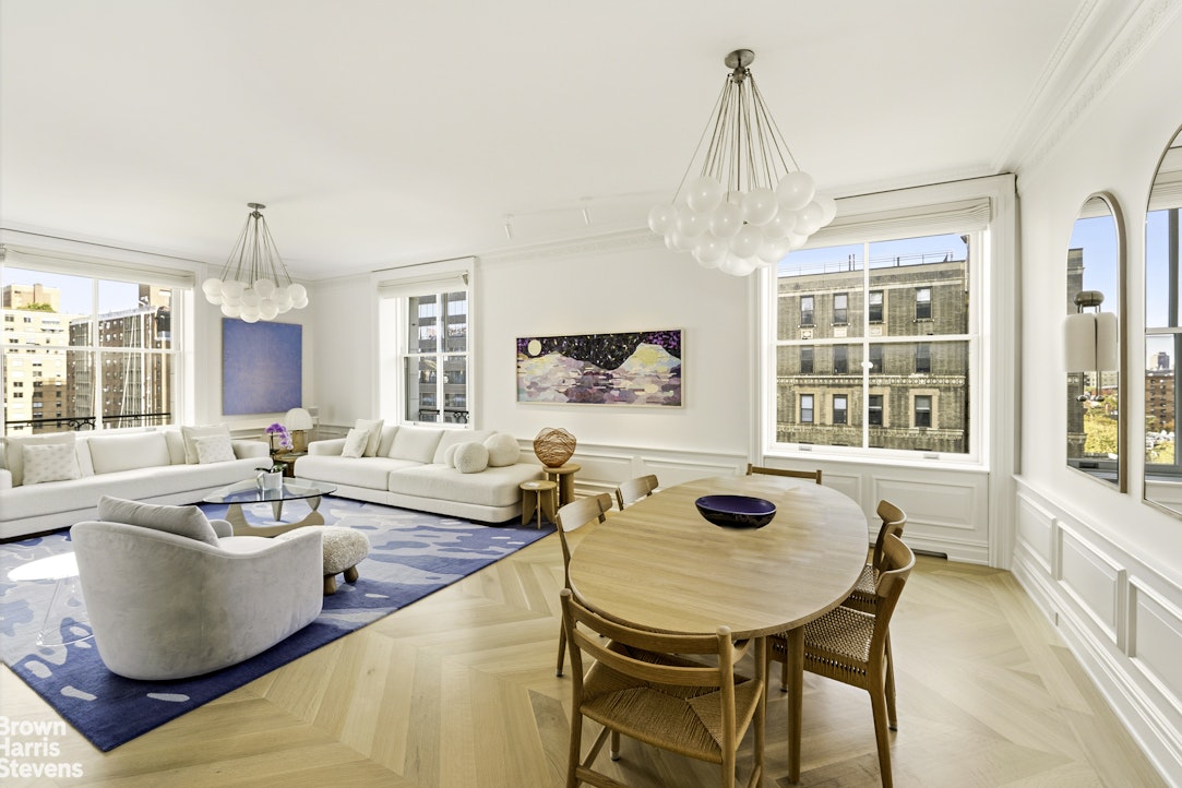 a living room with fireplace furniture and a chandelier