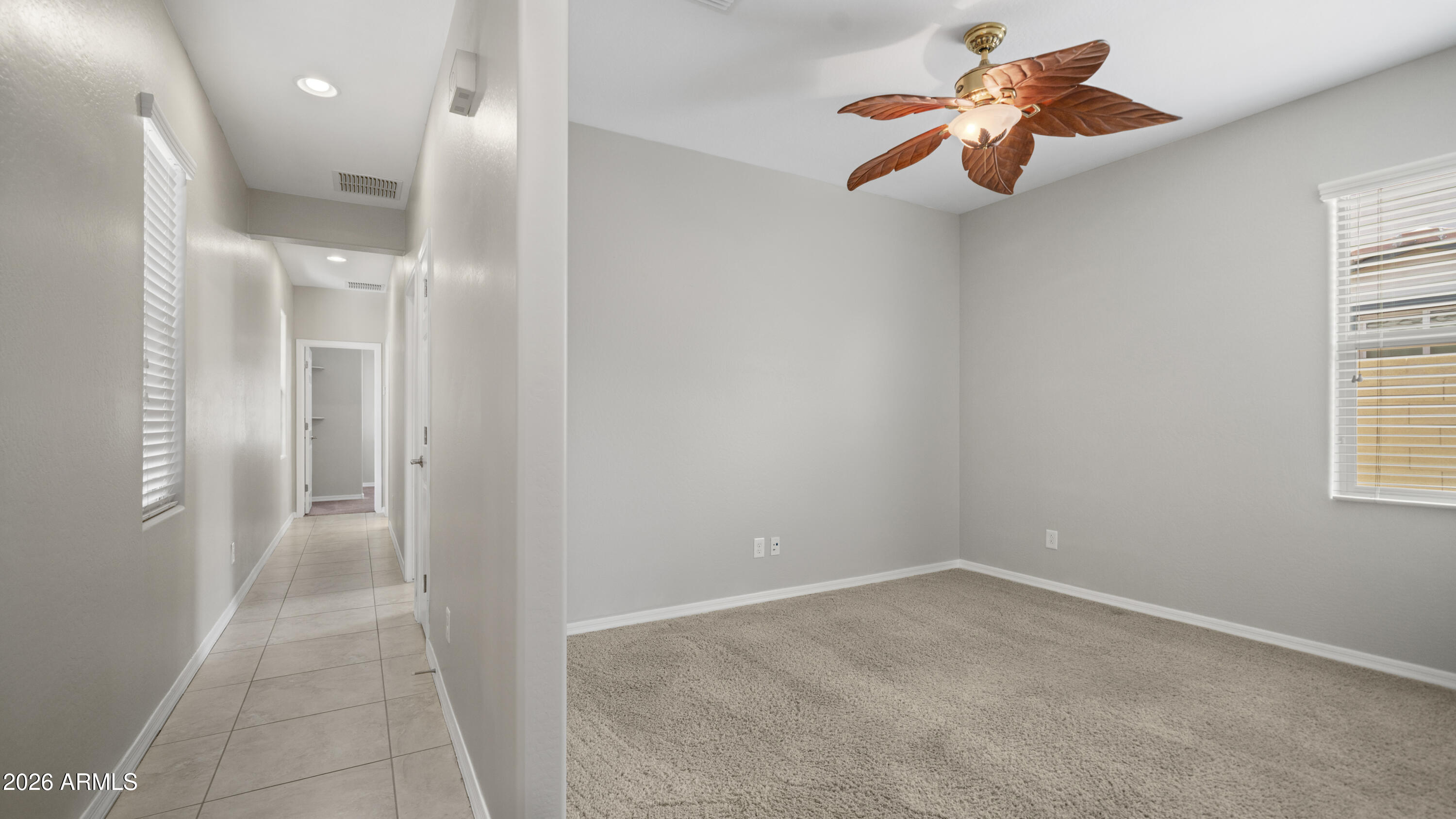16159 West Granada Road Goodyear, AZ 85395 - Photo 29 of 41 an empty room with chandelier fan and windows